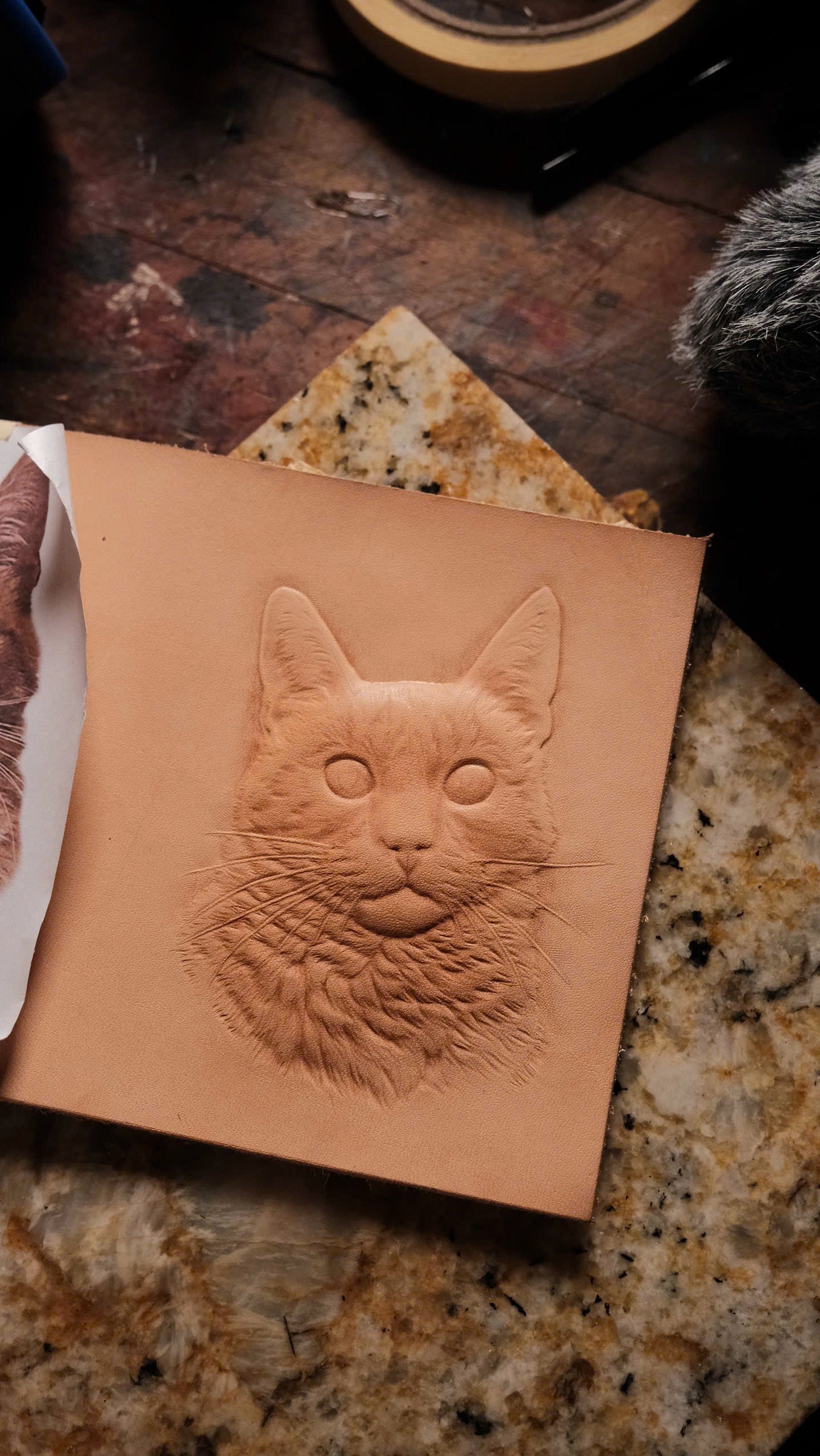 The design cut and modeled into damp leather